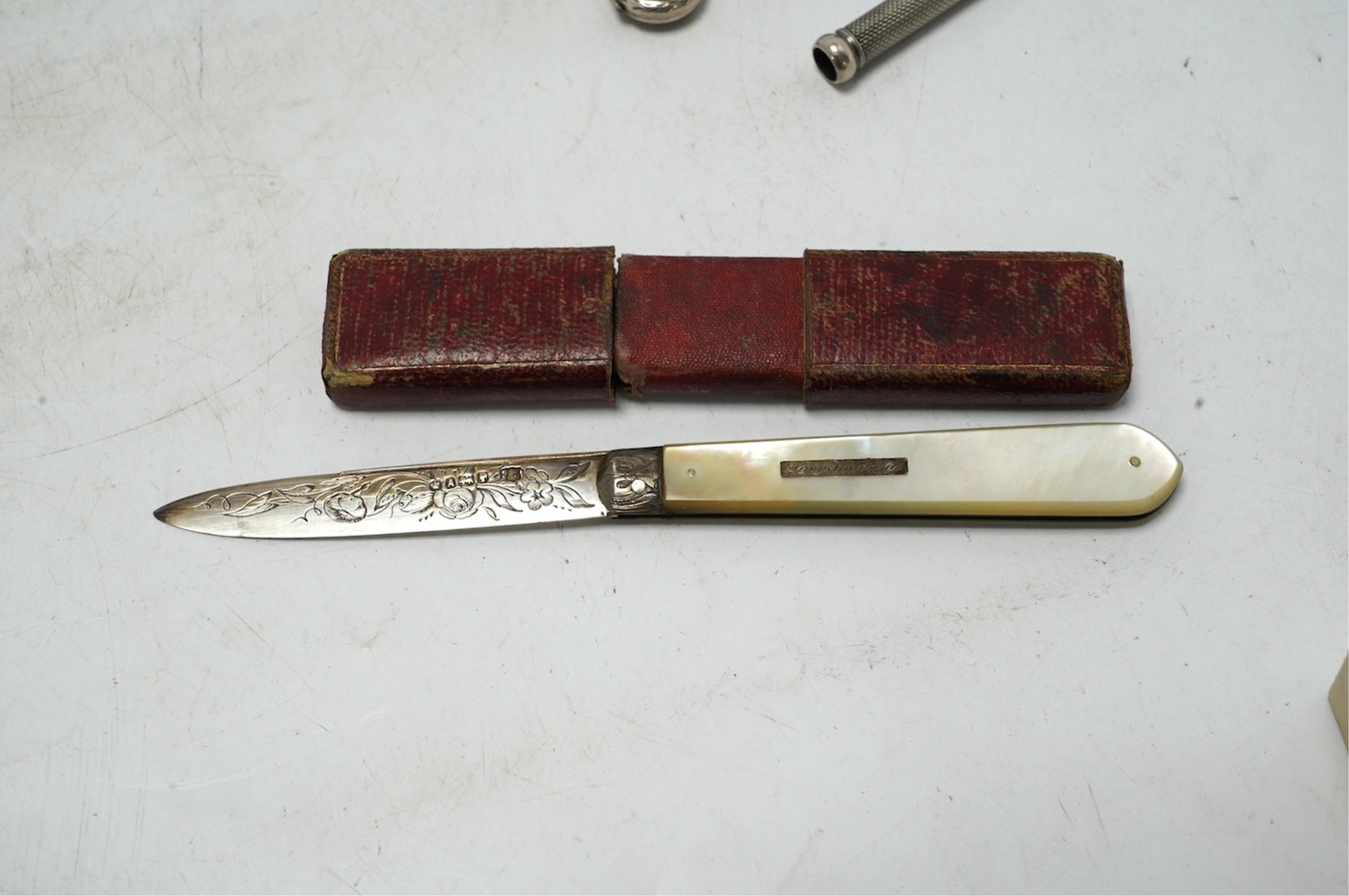 Small silver including a Victorian silver and mother of pearl fruit knife, a crucifix, a book mark, pencils, a thimble, etc. Condition - fair